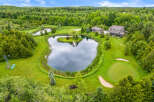 Discover this stunning estate featuring a private pond with a charming island and dock, perfect for serene moments.
