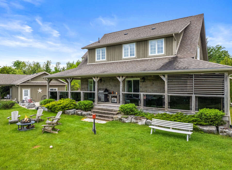 Enjoy outdoor living with this charming property featuring a spacious covered porch perfect for entertaining, complete with a grill and comfortable seating.