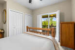 This cozy bedroom features a rustic log bed and a convenient access to the outdoors through a sliding glass door.