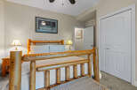 Experience rustic charm in this cozy bedroom featuring a beautiful log bed frame and matching nightstands.