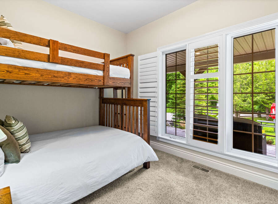 This charming bedroom features a sturdy wooden bunk bed, perfect for accommodating guests or children.