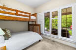 This charming bedroom features a sturdy wooden bunk bed, perfect for accommodating guests or children.