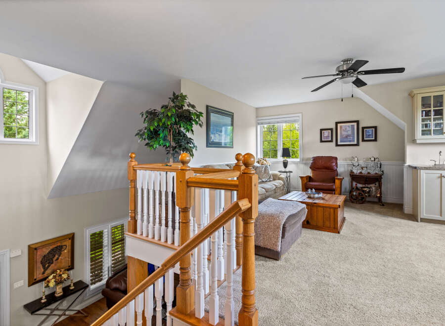 Ascend to this charming loft living area, featuring a cozy seating arrangement perfect for relaxation.