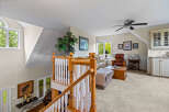 Ascend to this charming loft living area, featuring a cozy seating arrangement perfect for relaxation.