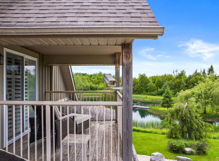 Enjoy serene waterfront living from this charming property, featuring a private balcony overlooking a tranquil lake and lush greenery.