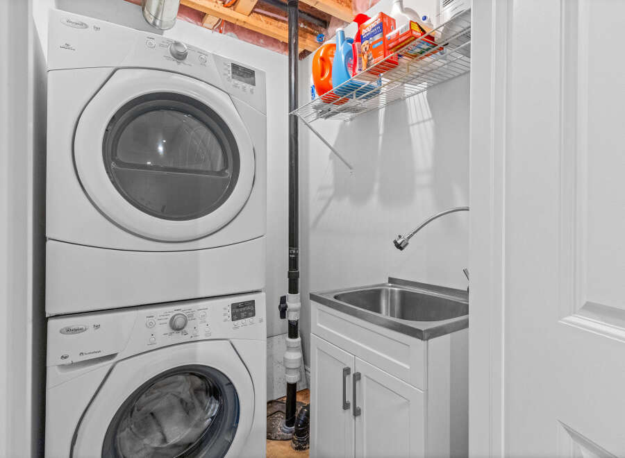 Discover a functional laundry space featuring a stacked Whirlpool Duet washer and dryer set, perfect for maximizing utility in your home.