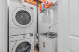 Discover a functional laundry space featuring a stacked Whirlpool Duet washer and dryer set, perfect for maximizing utility in your home.