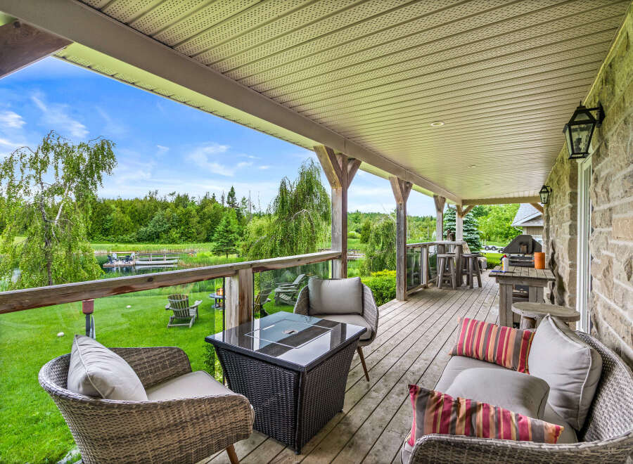 Enjoy breathtaking lake views from this expansive covered deck, perfect for entertaining or relaxing.