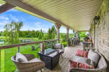 Enjoy breathtaking lake views from this expansive covered deck, perfect for entertaining or relaxing.