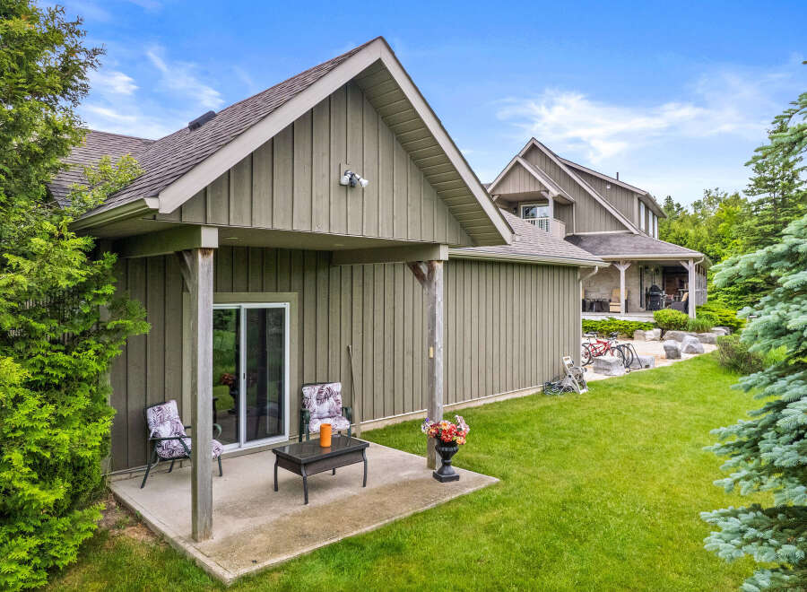 Enjoy outdoor living with this charming patio area featuring comfortable seating and a coffee table, perfect for relaxing evenings.