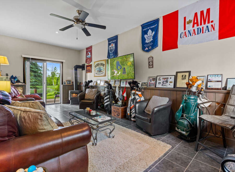 Step into this ultimate man cave, perfect for the sports enthusiast! Featuring comfortable leather seating, a cozy fireplace, and a dedicated space for golf clubs, this room is designed for relaxation and entertainment.