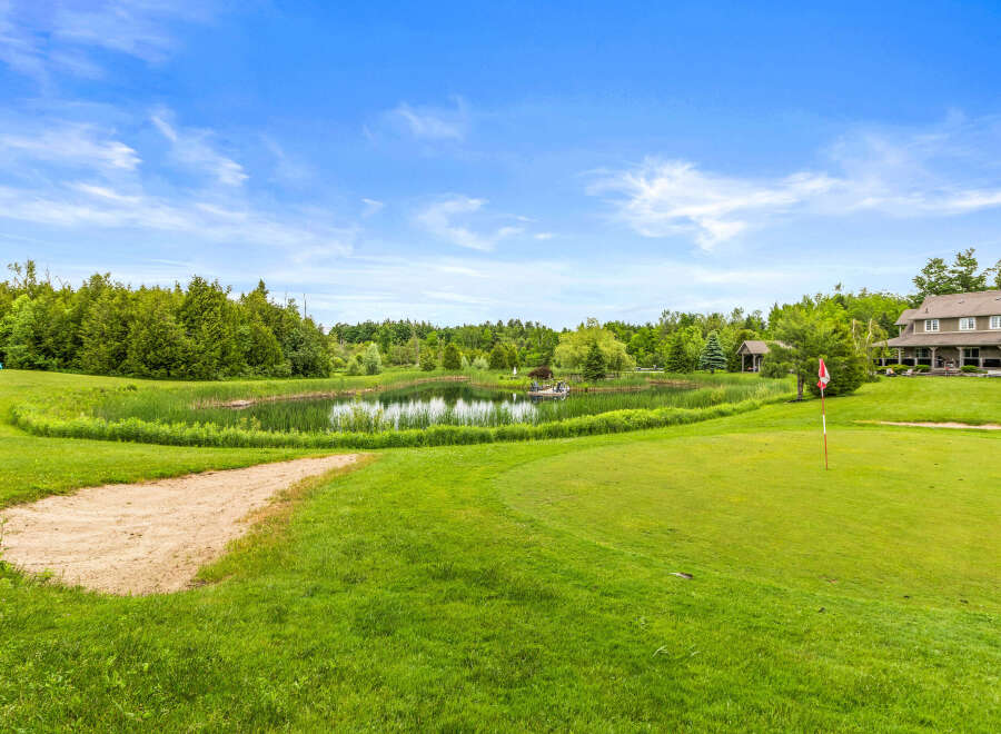 Experience luxury living with this stunning property featuring a private pond and lush green golf course views.