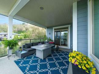 Enjoy outdoor living on this spacious covered patio, perfect for entertaining or relaxing.