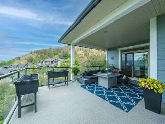 Enjoy breathtaking views from this spacious covered deck, perfect for entertaining or relaxing.