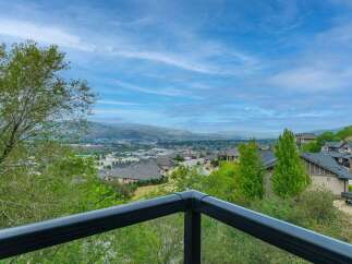Experience breathtaking panoramic views from this stunning property, offering a picturesque vista of the valley and distant mountains.