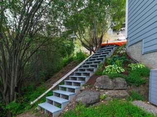 Ascend to your private oasis with this charming outdoor staircase, leading to a vibrant garden and a serene retreat.