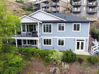 Discover this stunning light blue home featuring a multi-level design with ample windows for natural light.