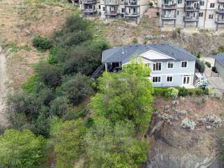 Discover this stunning multi-level home nestled on a scenic hillside, offering breathtaking views and ample living space.