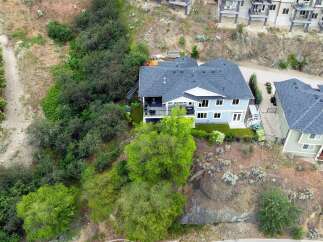 Discover this stunning multi-level home nestled on a hillside, offering breathtaking views and ample living space.