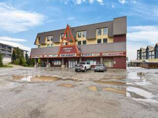 Discover prime commercial space at Whitefoot Lodge, featuring a vibrant mix of businesses including The Market, a pizza place with delivery, and Globe Cafe Tapas Trattoria.
