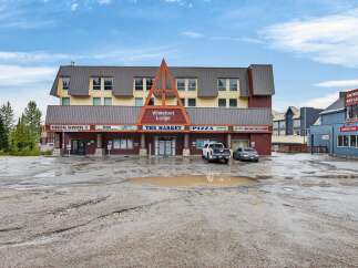 Discover commercial opportunities at Whitefoot Lodge, a multi-unit property featuring diverse businesses including Medical Services, The Market, Pizza, and Globe Cafe.