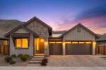 Experience luxury living in this stunning modern home, featuring a striking stone and wood exterior.