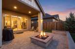 Enjoy cozy evenings in this backyard oasis, complete with a built-in fire pit and ample patio space for entertaining.