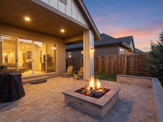Enjoy cozy evenings in this backyard oasis, complete with a built-in fire pit and ample patio space for entertaining.