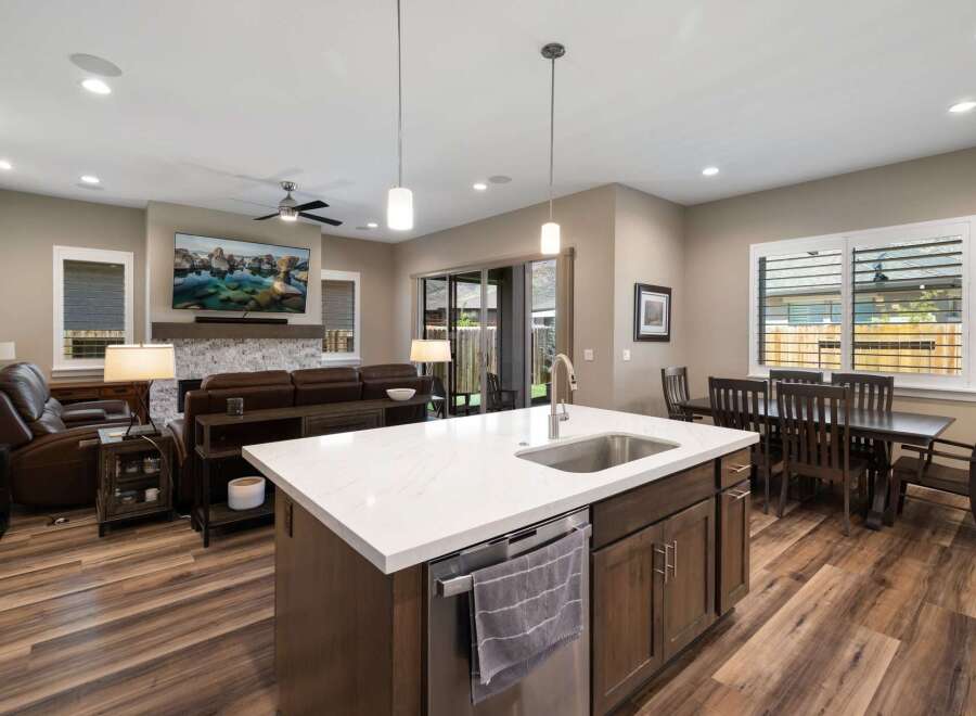 This spacious open-concept living area features a modern kitchen island with a sink, perfect for entertaining.