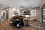 Experience modern living in this spacious living room, featuring a cozy fireplace and a large flat-screen TV perfect for entertainment.