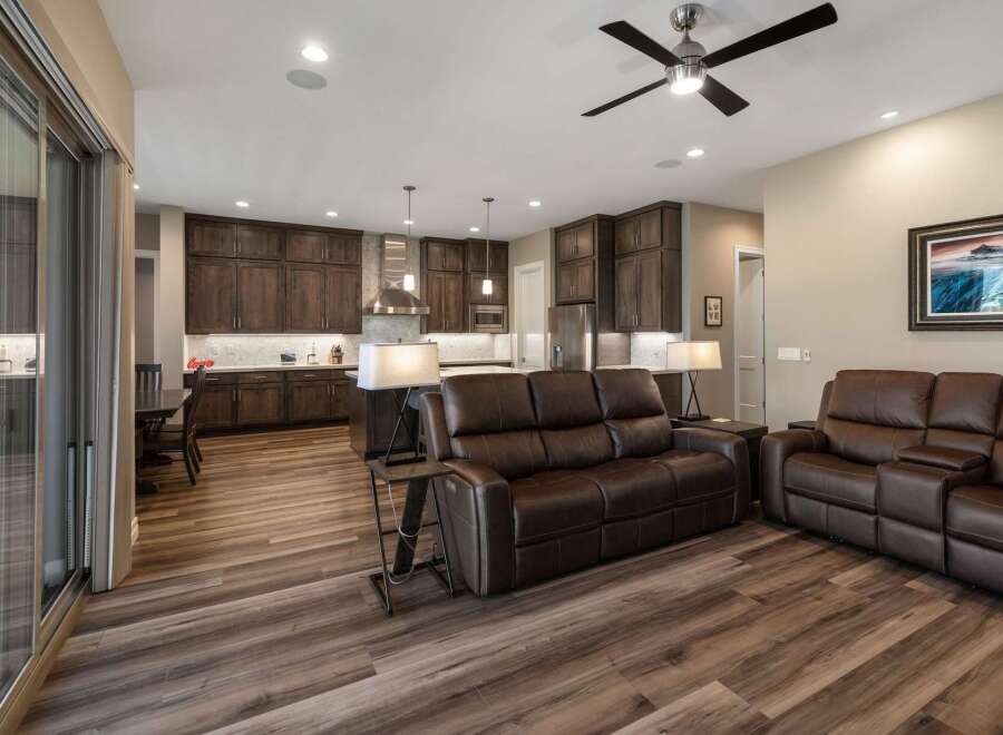 Experience modern living in this spacious open-concept home, featuring a gourmet kitchen with rich wood cabinetry and sleek countertops.