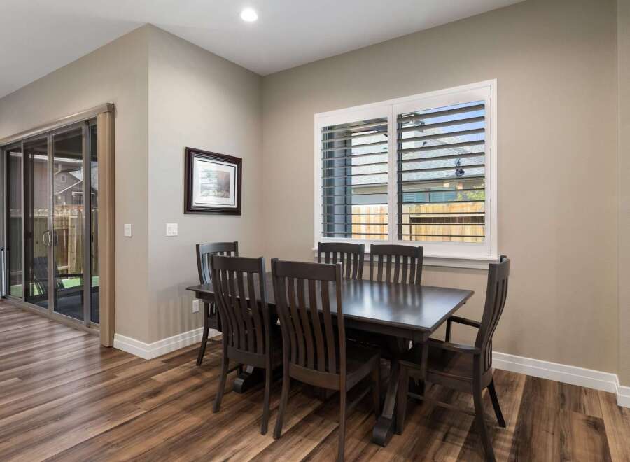 This dining area features a dark wood dining table with six matching chairs, perfect for family meals and entertaining.
