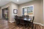 This dining area features a dark wood dining table with six matching chairs, perfect for family meals and entertaining.