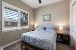 This cozy bedroom features a comfortable queen-size bed dressed in soft blue linens, perfect for a restful night's sleep.