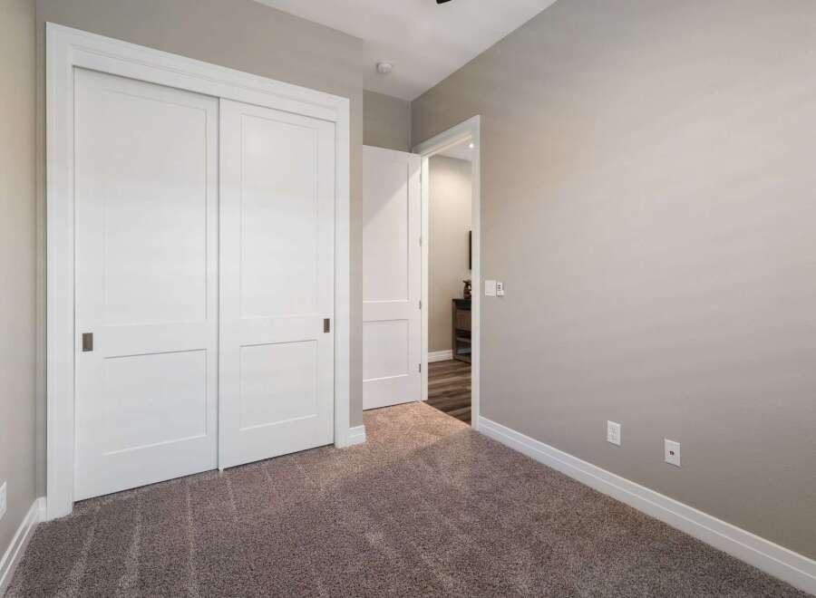 Step into this inviting room featuring a spacious closet with sleek sliding doors, perfect for ample storage.