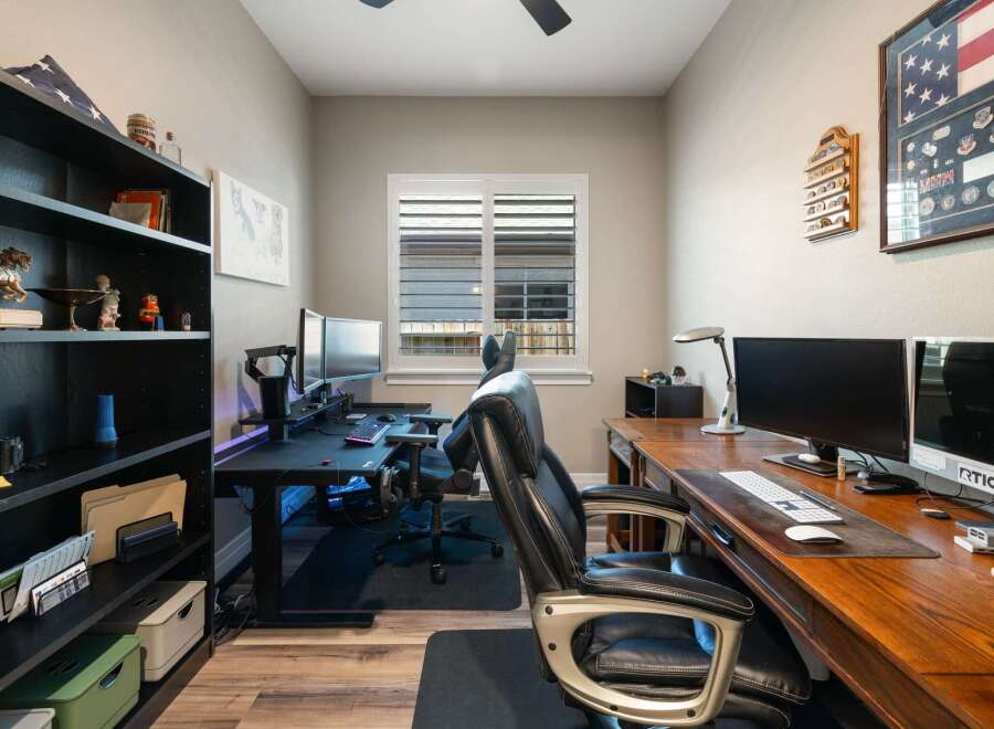 This home office features two distinct workstations, perfect for productivity or gaming.