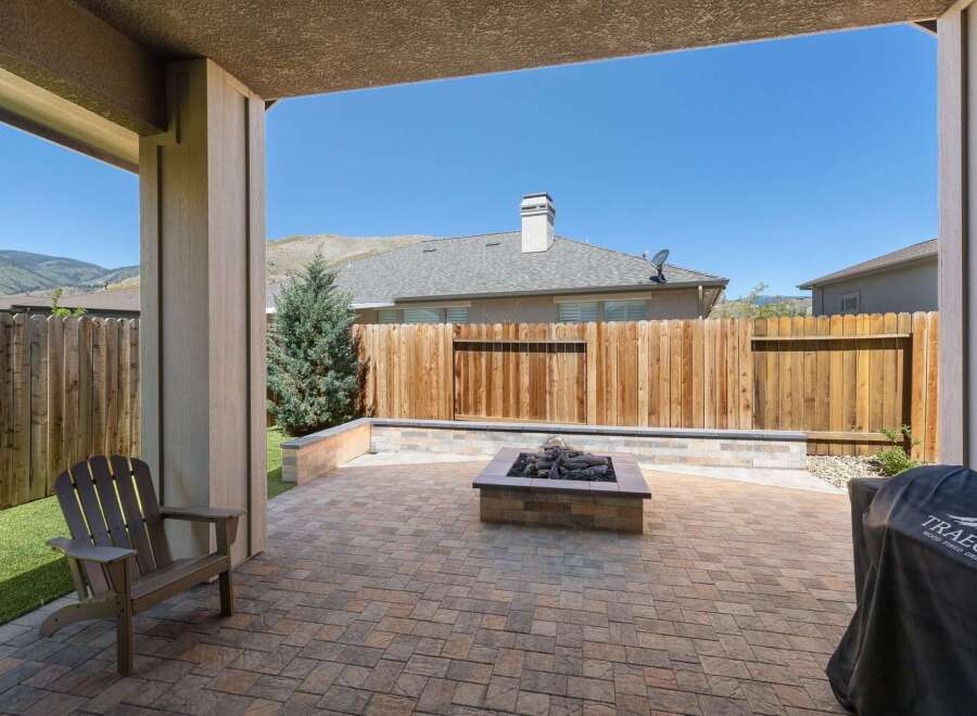 Enjoy outdoor living with this spacious patio featuring a built-in fire pit, perfect for cozy evenings.