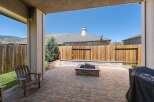Enjoy outdoor living with this spacious patio featuring a built-in fire pit, perfect for cozy evenings.
