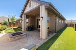 Enjoy outdoor living with this beautifully designed backyard featuring a modern gas fire pit and a spacious paved patio perfect for entertaining.