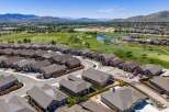 Discover modern living in this stunning aerial view of a suburban neighborhood adjacent to a lush golf course.