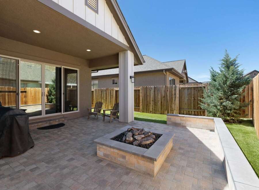 Enjoy outdoor living in this spacious backyard featuring a covered patio perfect for entertaining.