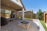 Enjoy outdoor living in this spacious backyard featuring a covered patio perfect for entertaining.