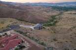 Experience luxury living in this stunning custom-built estate, nestled amidst rolling hills with panoramic city views.