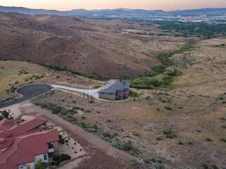 Experience luxury living in this stunning custom-built estate, nestled amidst rolling hills with panoramic city views.