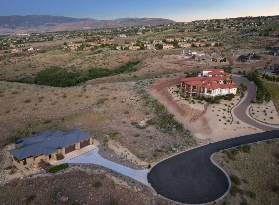Discover luxury living in this stunning estate, featuring a sprawling main residence with a red tile roof and expansive balconies, perfect for enjoying panoramic views.