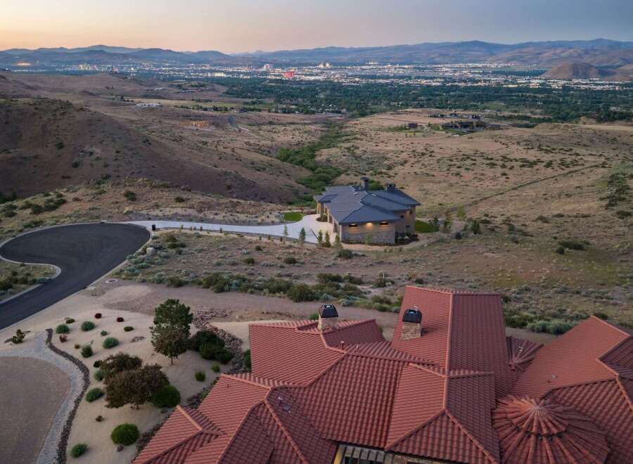 Experience luxury living with this stunning estate offering panoramic views of the city lights and surrounding mountains.
