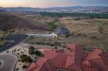 Experience luxury living with this stunning estate offering panoramic views of the city lights and surrounding mountains.