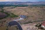 Experience luxury living in this stunning modern home, nestled in a serene, elevated landscape with panoramic views of the distant city and mountains.