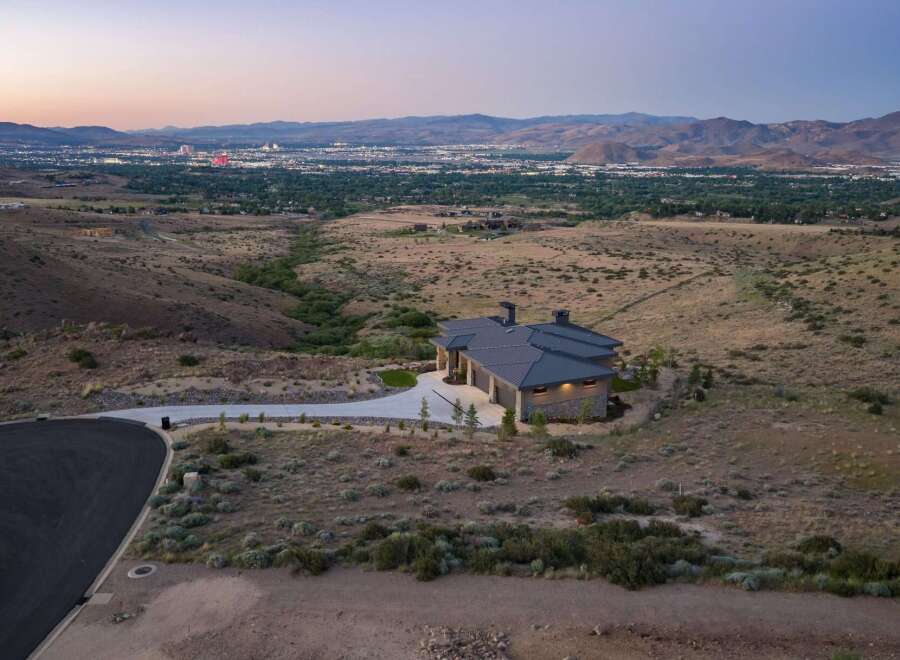 Experience luxury living in this stunning modern home, nestled on a hillside with panoramic views of the city lights and surrounding mountains.