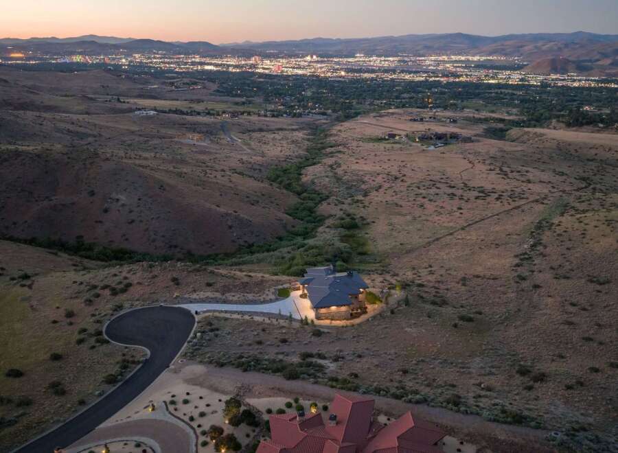 Experience luxury living with this stunning estate nestled in the hills, offering panoramic views of the city lights below.